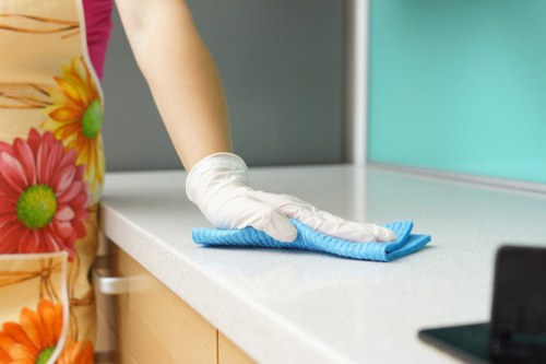 Cleaning staff applying health and safety procedures in a professional setting
